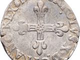 a close up of a coin with a cross on it