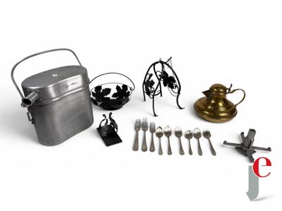 a lot of silverware on a white table