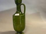 an image of a green vase with a light on top of it