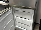 a silver refrigerator in the corner of a kitchen