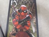 marvel deadpool comic book and cassette laying on the floor
