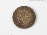 a coin that is sitting on a white surface