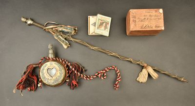 a small wooden box and a stick with a picture on it
