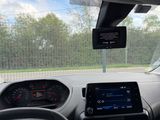 dashboard view of a car with a monitor and a tablet on the dashboard