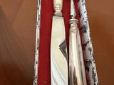 a knife, fork, and spoon in a box on a table