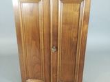 an image of a wooden cabinet with two doors and a door handle