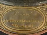 a close up of a gold plate with a clock on it