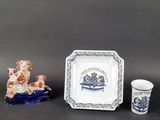 three pieces of blue and white pottery including a plate, cup, and saucer