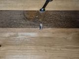 a piece of wood that has a nail stuck in it