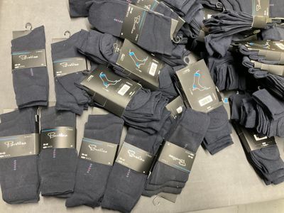 many pairs of black socks on a table