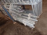 a pile of metal pipes stacked on top of each other in a warehouse