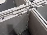four white boxes with metal latches in a room