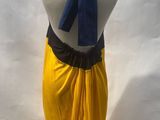mannequin dressed in yellow and black with a blue scarf