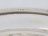 a close up of a silver plate with a clock on it