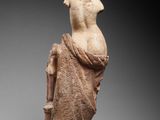 an ancient statue of a man with a scarf around his neck