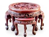 three stools and a table with carvings on them