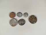 six different types of coins are shown on a white surface
