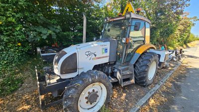 a tractor that is parked on the side of the road