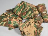 a pile of camouflage clothing on a white surface