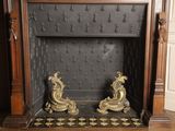 a fireplace that has two statues on top of it