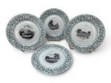 four blue and white plates with black and white images on them