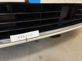 a close up of a car ' s grille with a sticker on it