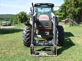 a tractor that is parked in the grass