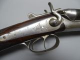 an old gun with a wooden handle on a table