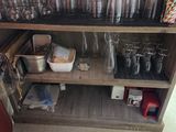 a shelf with many glasses on it in a room