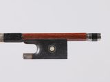 a close up of a violin bow on a white surface