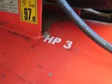 a red gas tank with a hose attached to it
