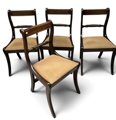 four chairs with a brown seat and a brown cushion on them