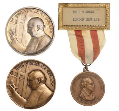 three medals with a plaque on each of them and a plaque on the other
