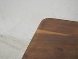 a brown wooden table with a white wall in the background
