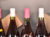 several bottles of wine are lined up in a row on a table