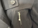 a close up of the zippers on a black jacket