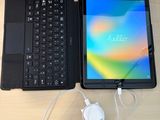 a laptop and a tablet on a table with a charger