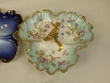 two decorative dishes that are sitting on a table