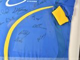 a picture of a signed jersey in a display case