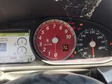 a car dashboard with a clock and a cell phone in it