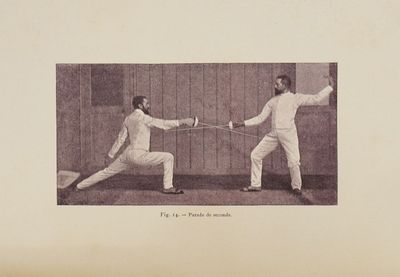 two men that are fencing in a fenced in area