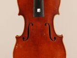 an old violin with a bow hanging from it ' s back
