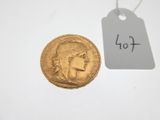 a close up of a gold coin with a price tag on it