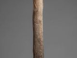 a close up of a wooden stick on a gray surface