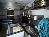 a kitchen with a sink and a lot of pots and pans