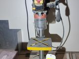 a drill on a table with a lot of tools on it
