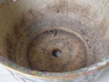 a close up of a bowl with a hole in it