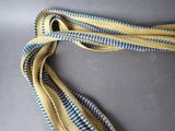 yellow and blue striped tie on a gray surface