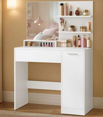a white vanity with a mirror and bottles of perfume on it