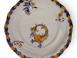 a white plate with a blue and yellow design on it